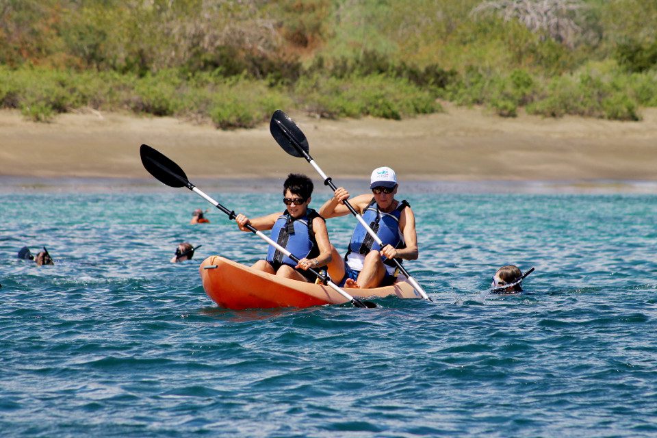 Couple Kayaking In Galapagos.