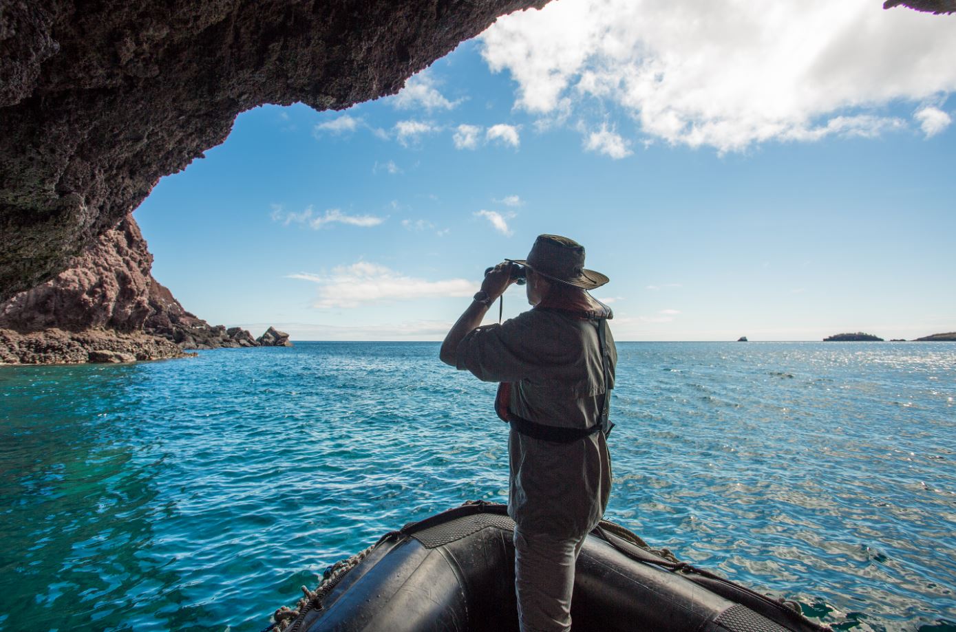 Guest Viewing Rock Formations In The Galapagos Islands.