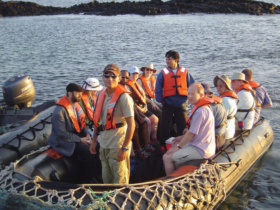 A Galapagos Naturalist Guide With Our Guests On A Panga.