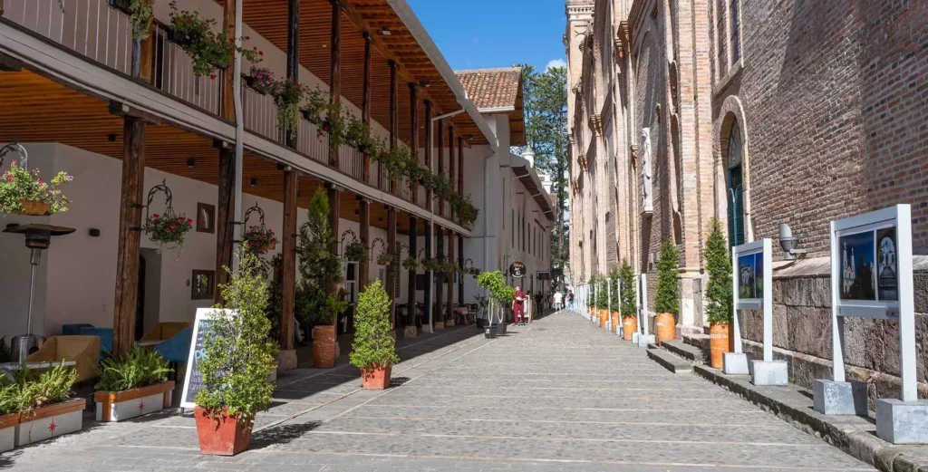 Cobblestone Santa Ana Street with outdoor cafes in Cuenca