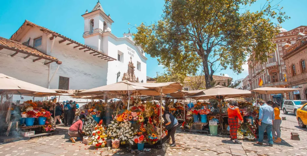 Flower vendors at Plaza de las Flores market in Cuenca