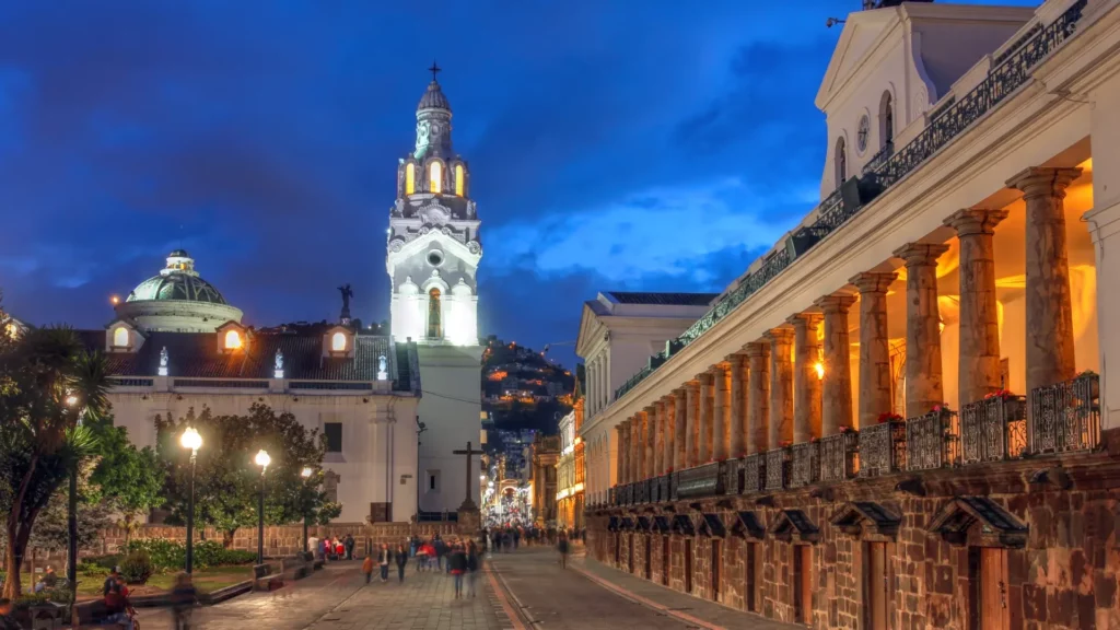 Plaza Grande and the Presidential Palace colonnade at dusk in Quito