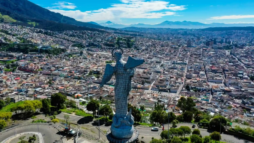Panoramic view of Quito with the Virgin of El Panecillo statue overlooking the city.