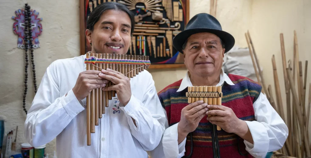 Musicians from Peguche holding hand-crafted bamboo panpipes