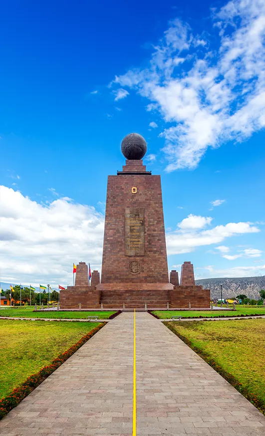 Mitad del Mundo monument with equator line marked on the entrance pathway, Quito Ecuador