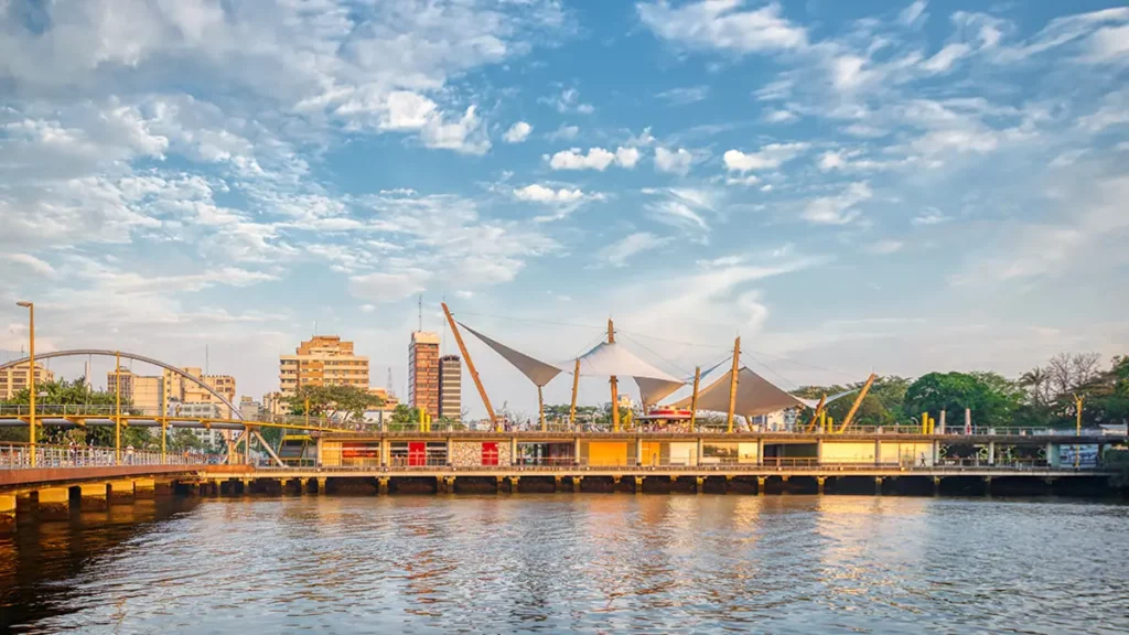 Guayaquil port waterfront with cranes and city buildings reflected in the Guayas River