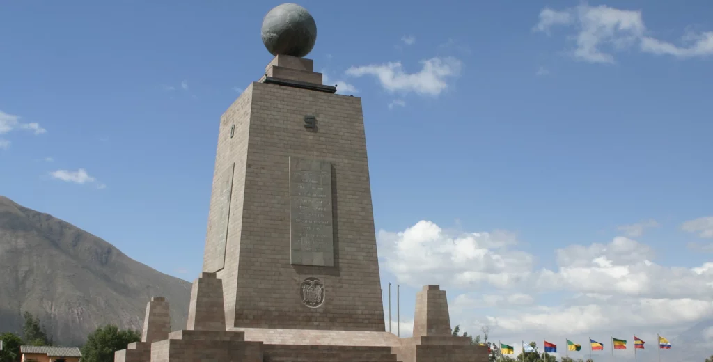 Mitad del Mundo monument with international flags