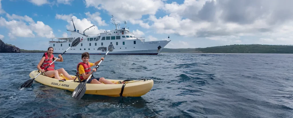 Mother and son kayaking during the Galapagos Origin of Species Cruise aboard Yacht La Pinta.