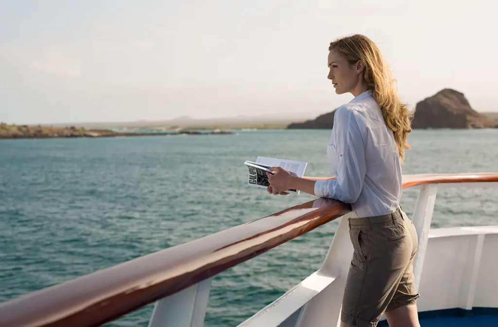 Guest relaxing on the sun deck of Yacht Isabela II overlooking the Galapagos