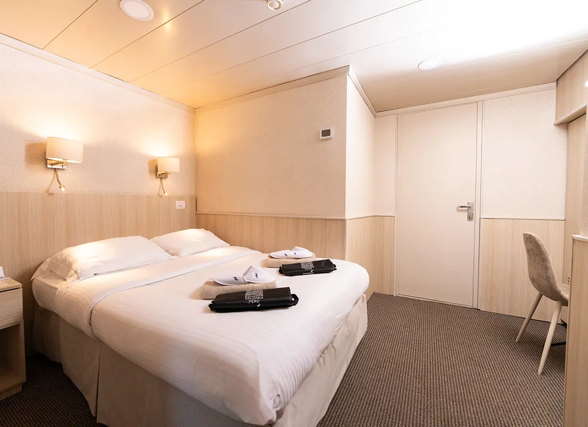 Standard Double Cabin Aboard Yacht Isabela Ii With White Linens And Wooden Interiors Standard Double Cabin Aboard Yacht Isabela Ii With White Linens And Wooden Interiors