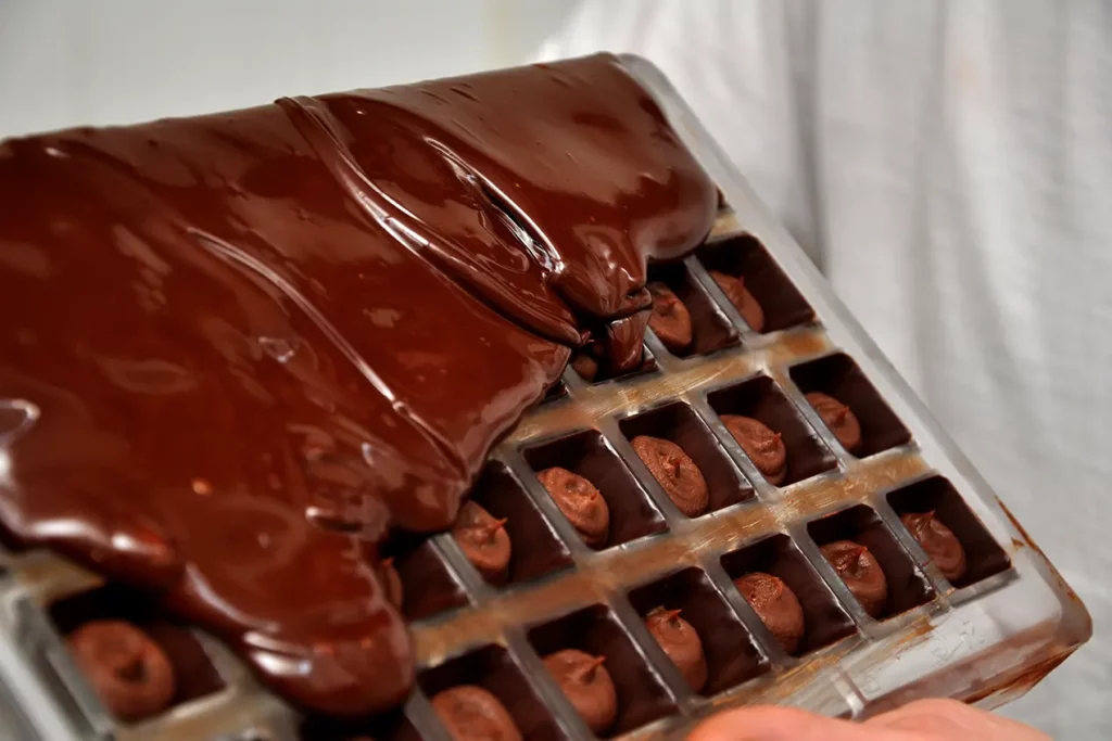 Handmade chocolates being crafted at a Quito chocolatería