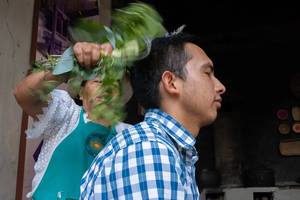 Traditional healer performing a spiritual cleansing ceremony with plants
