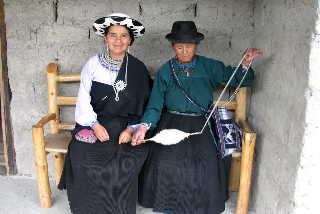 Saraguro Kichwa women weaving wool in traditional dress