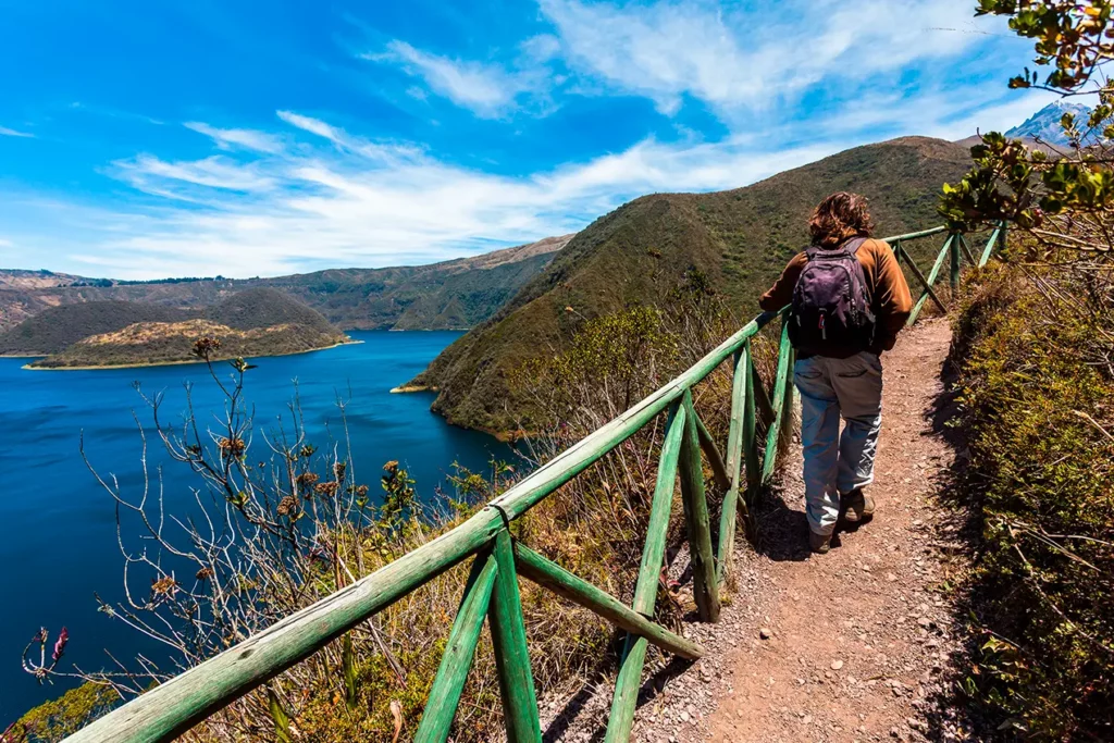 Hiker on the trail overlooking Cuicocha Lagoon and its island