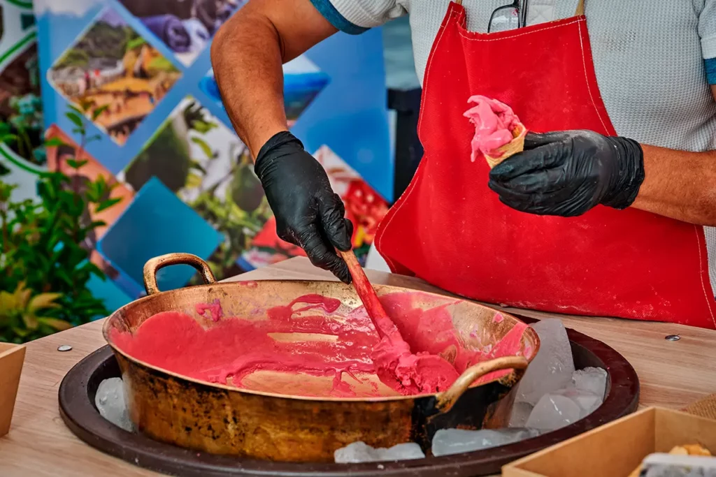 Traditional helado de paila being prepared in a copper basin over ice