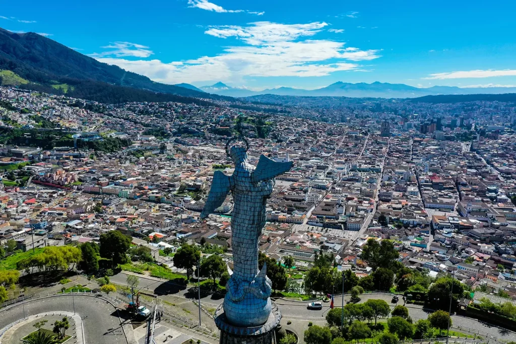 Panoramic view of Quito from El Panecillo with Andean volcanoes in the distance