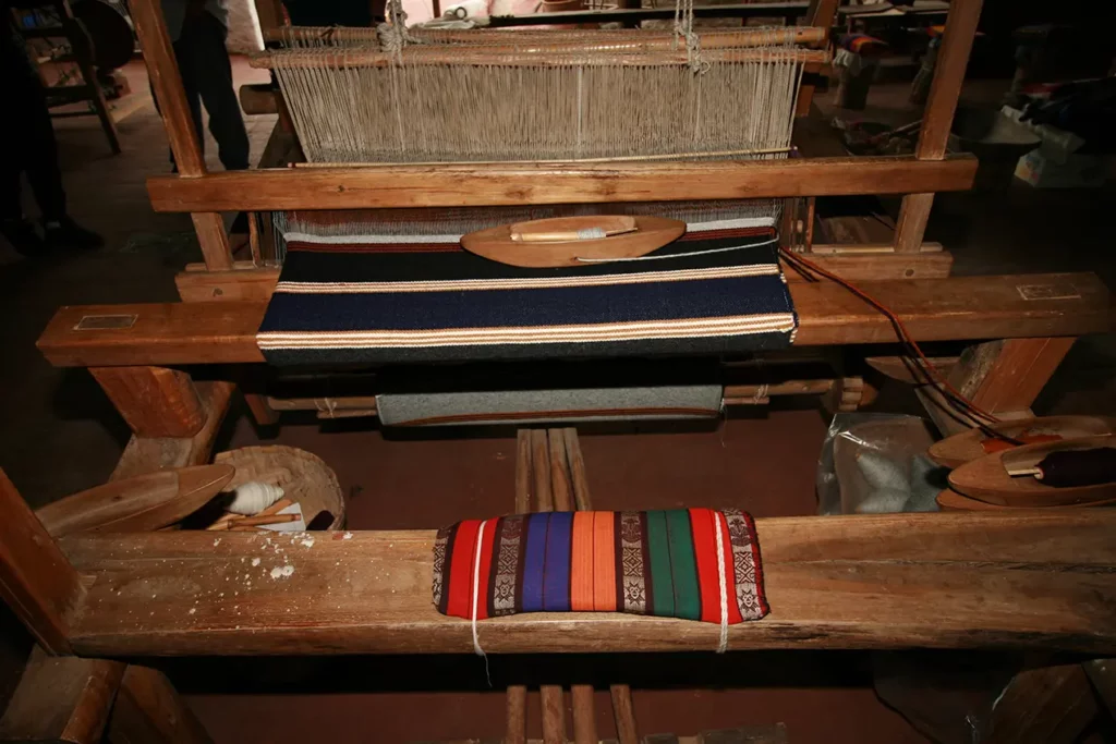 Traditional wooden loom weaving textiles at the Peguche workshop