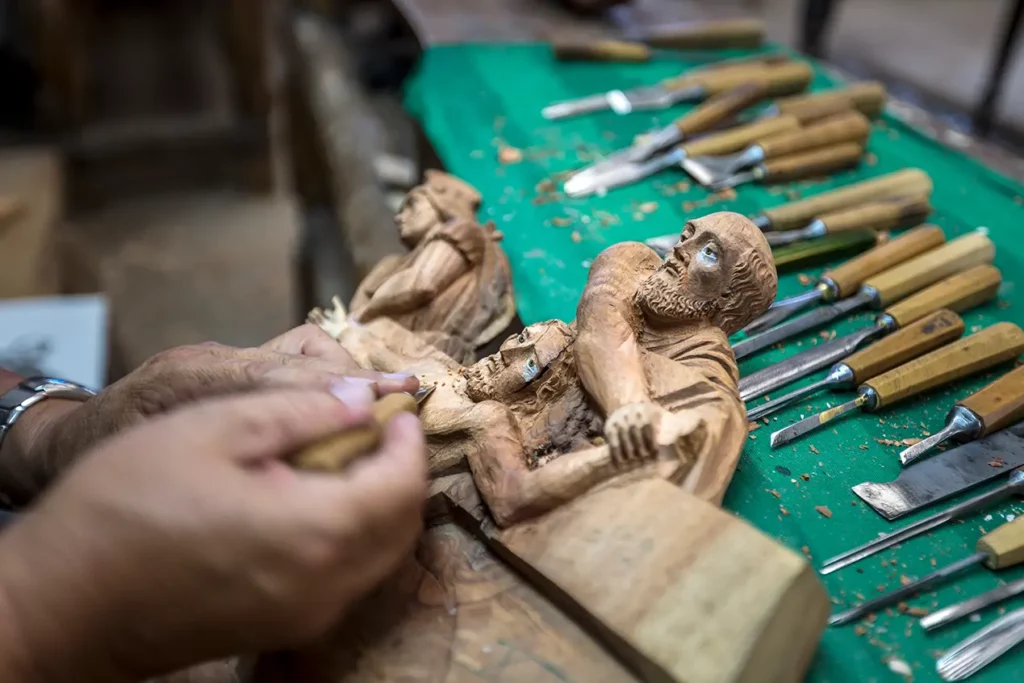Wood carving artisan at work in San Antonio de Ibarra, Ecuador