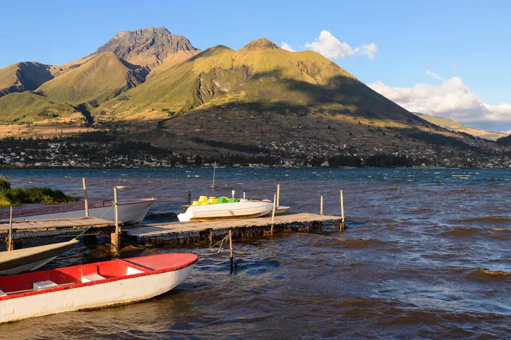 Boats docked on San Pablo Lake with Imbabura volcano in the background