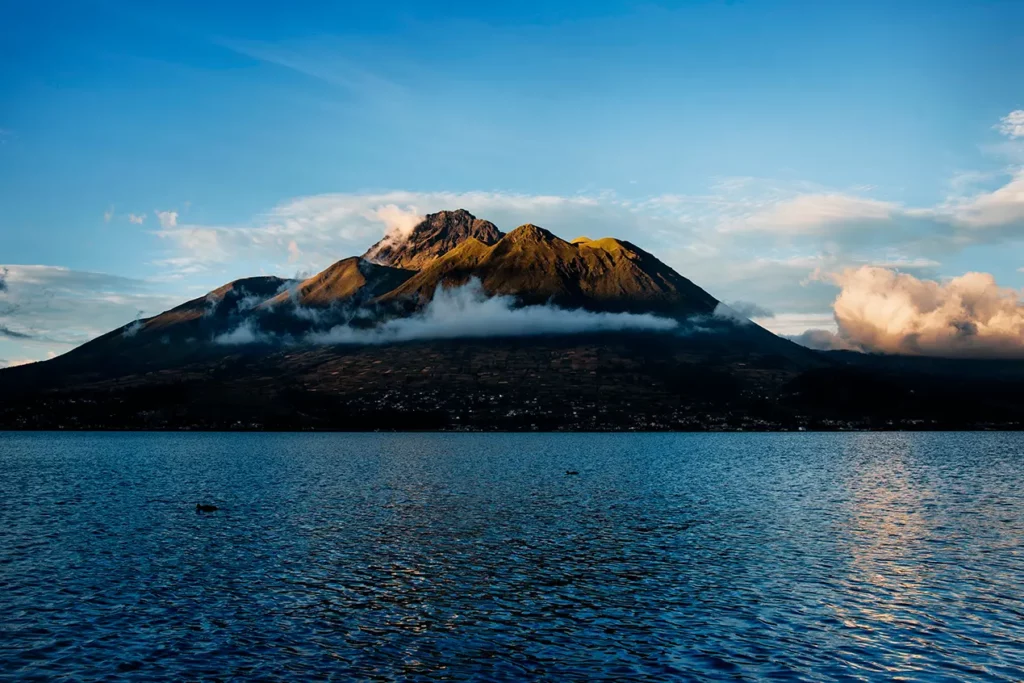 Imbabura volcano rising over San Pablo Lake at dusk
