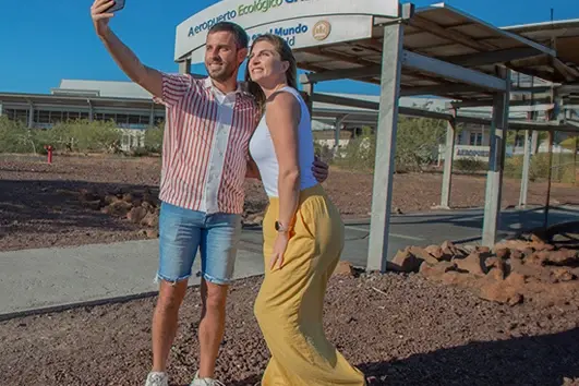 Couple taking a farewell selfie at Seymour Airport in the Galapagos Islands