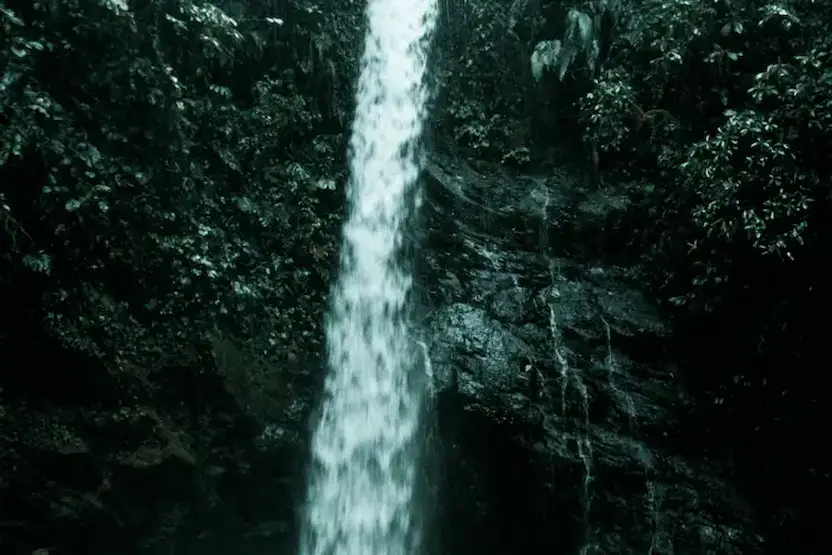 Tourists Enjoying A Galapagos Islands Waterfall